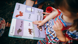 young girl reading a picture book