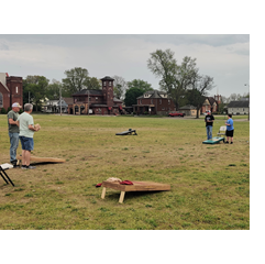 cornhole boards & people playing