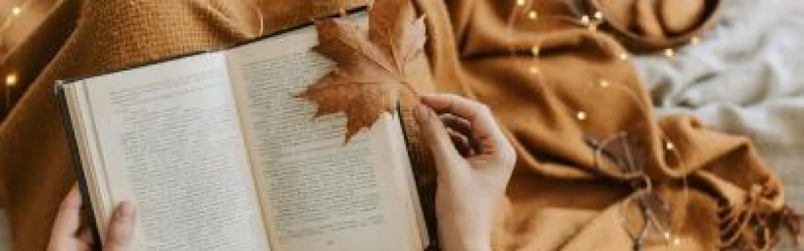 open book and fall leaves
