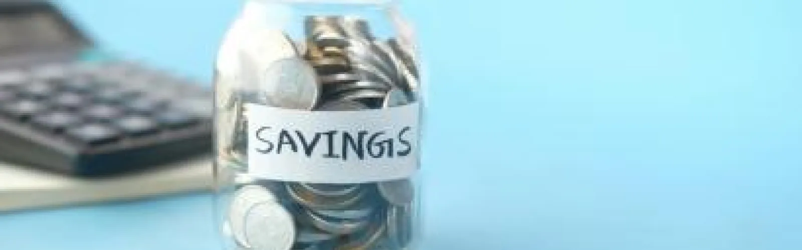 money jar with "savings" label 
